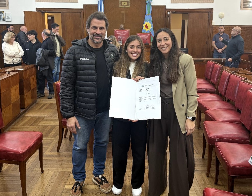 Pilar posa con el reconocimiento junto a los directivos de Mar del Plata Club, Jerónimo Rocatti y Celina Bustamante.